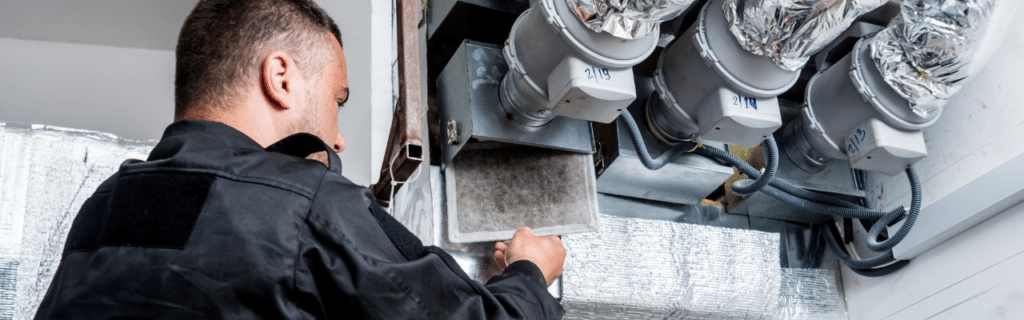HVAC Technician checking an air filter.