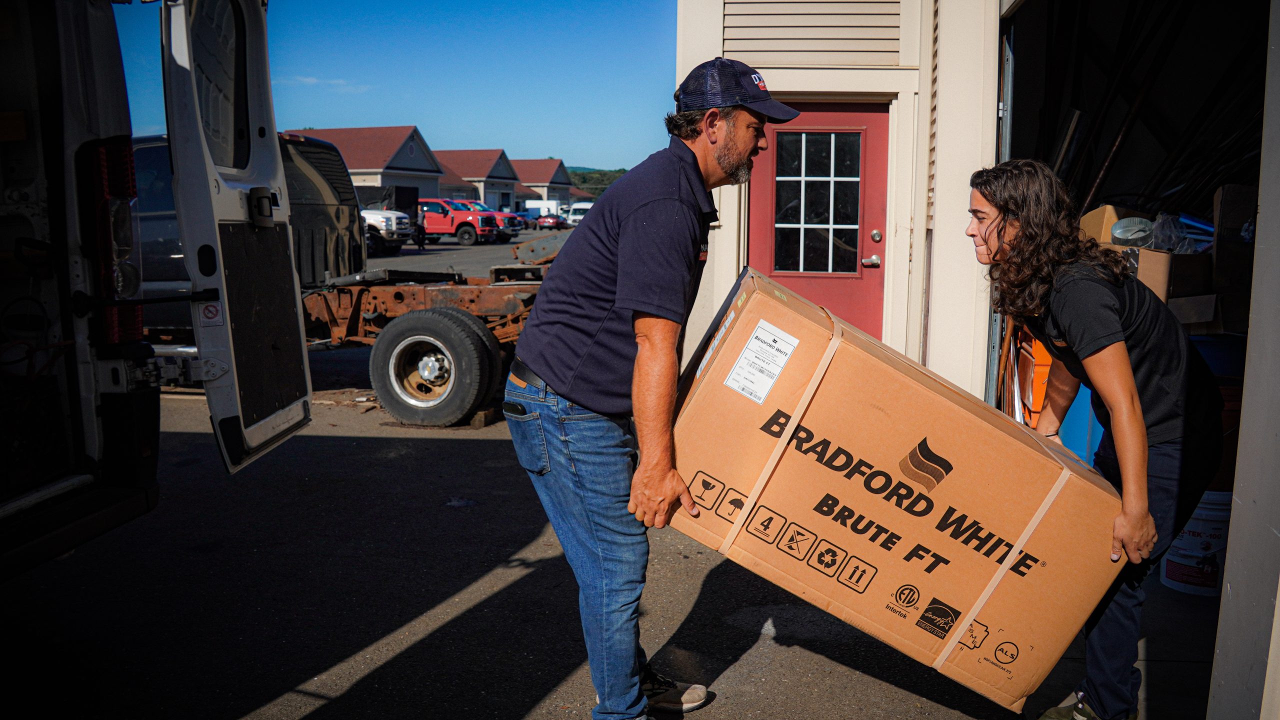 Workers carrying hvac materials